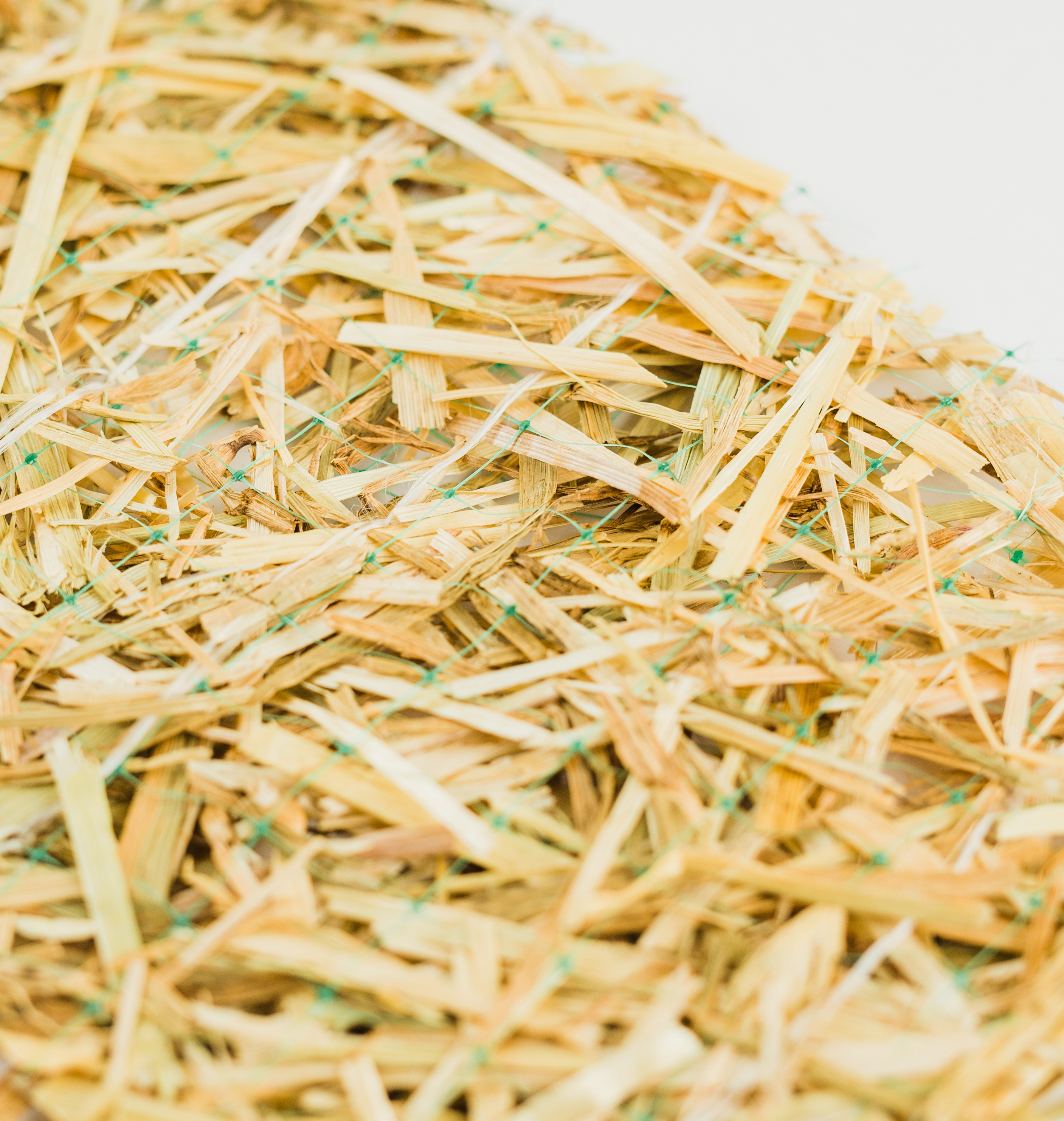 Agricultural straw securely sewn together with polypropylene netting