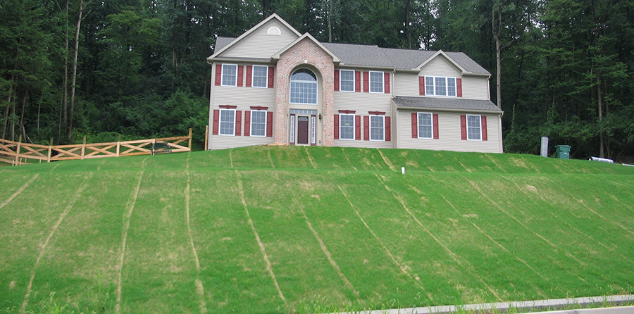 erosion control RECP blankets being used to restore grass in a residential construction project